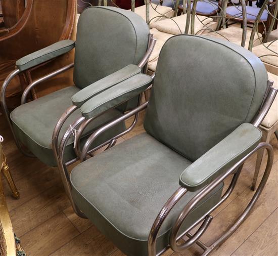 A pair of chrome plated and green vinyl scroll framed elbow chairs